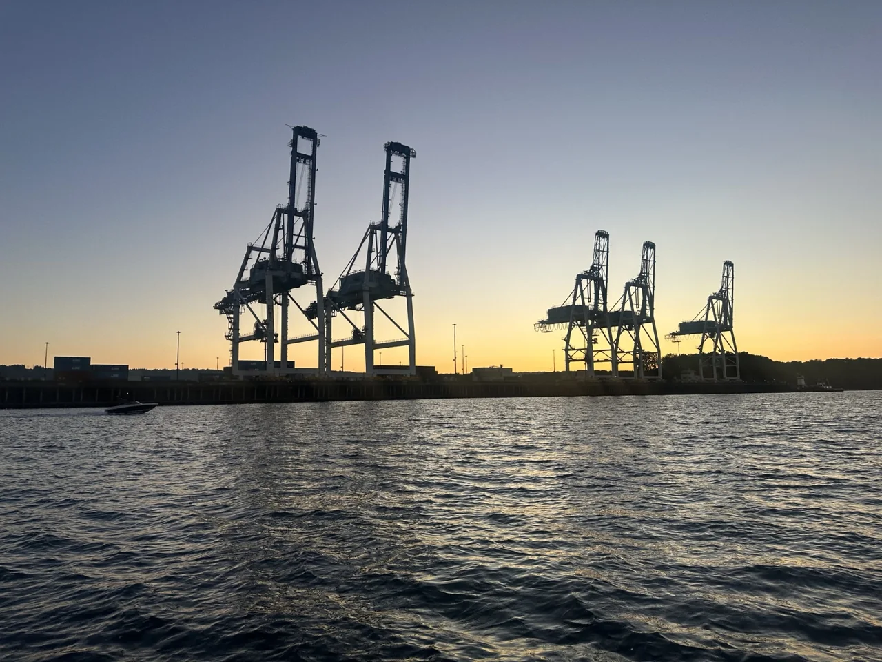 Container cranes on the Columbia River waterfront at sunset, photographed by Andrew Rider
